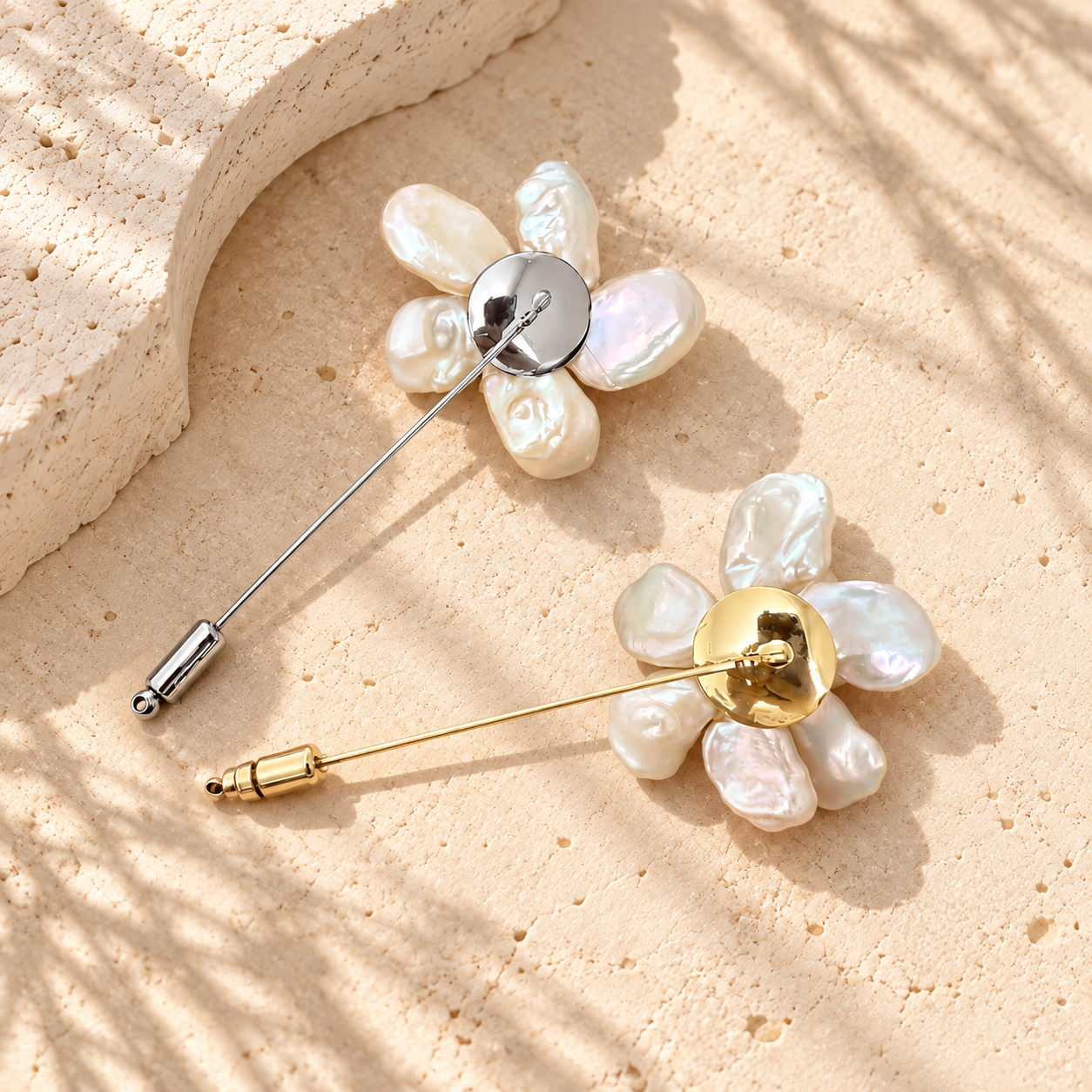 Reverse view of gold- and silver-toned pearl flower stick pins, showing circular back plates and end caps