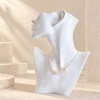 Side-drilled rice pearl cluster necklace displayed on a white bust