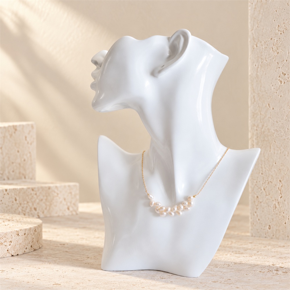 Side-drilled rice pearl cluster necklace displayed on a white bust