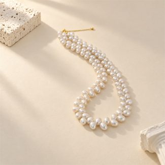 White rice pearl necklace with wheat-like paired pearl strands laid flat