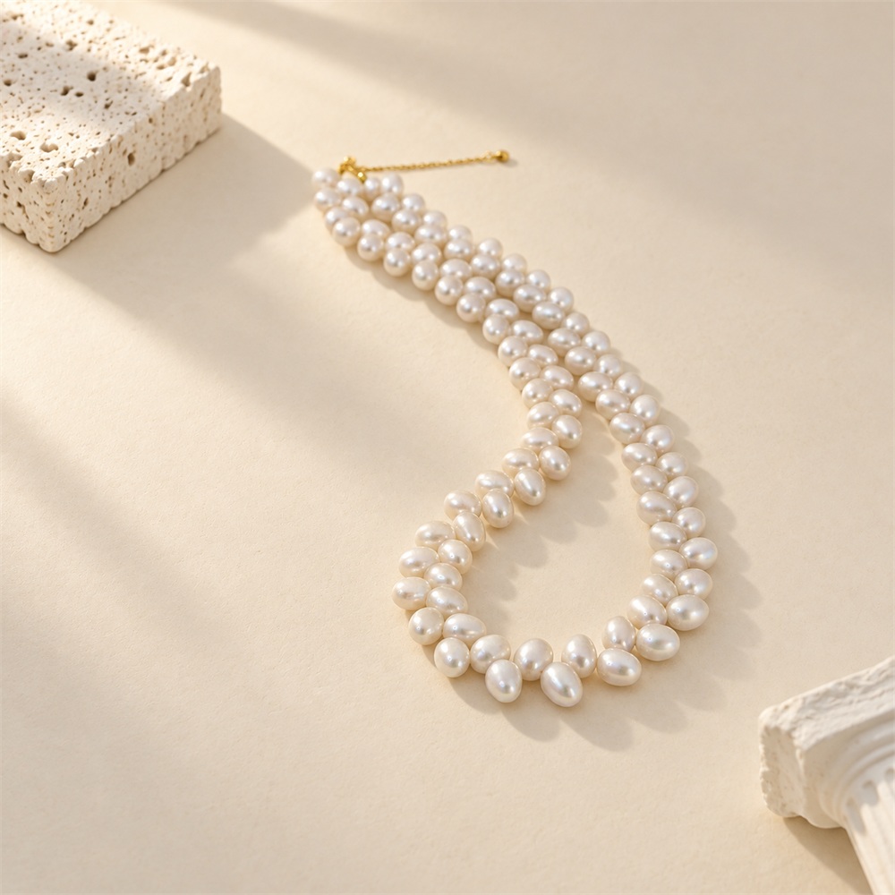 White rice pearl necklace with wheat-like paired pearl strands laid flat