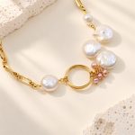 Close view of coin pearls, pink rice pearls and circular ring on an oval-link necklace