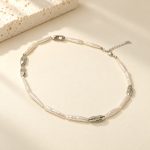 Silver-tone stick pearl collar necklace with irregular metal links laid flat