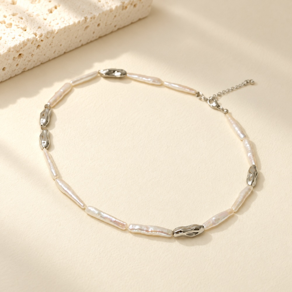 Silver-tone stick pearl collar necklace with irregular metal links laid flat