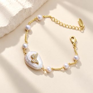 Butterfly-accented baroque pearl bracelet with freshwater pearl stations and extender laid flat