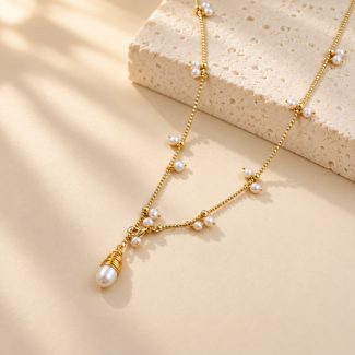 Close-up of a freshwater pearl fringe necklace with a wire-wrapped pearl pendant and front clasp