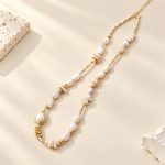 Shell fragment and freshwater pearl necklace arranged flat to show its irregular linked design