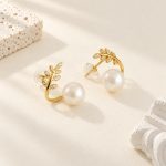 Side and back view of gold-toned olive leaf pearl studs showing posts and clear earring backs