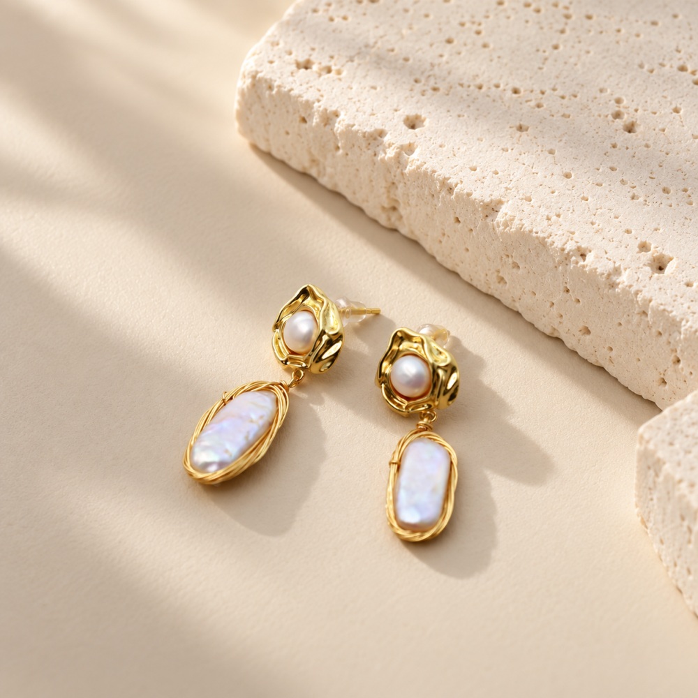 Baroque pearl earrings with small round pearls in molten-style golden settings