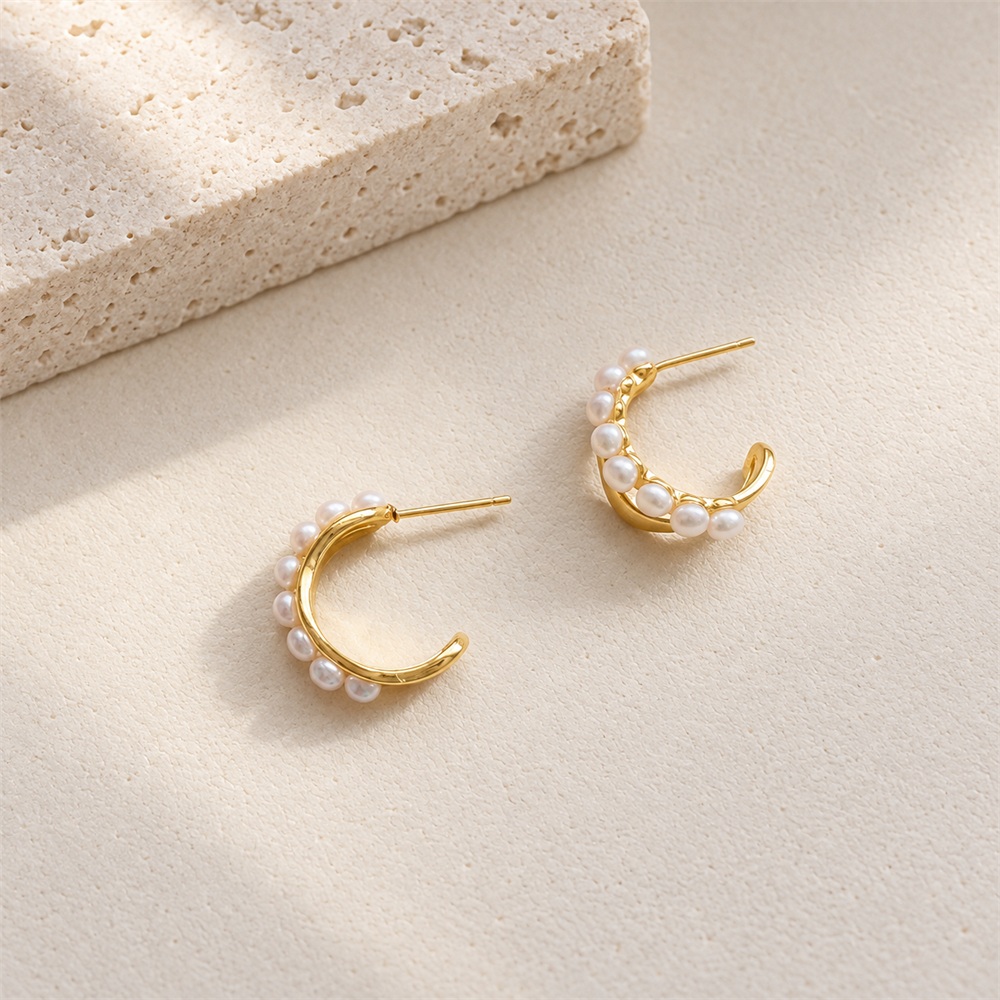 Side view of freshwater pearl crescent stud hoop earrings showing the post fastening