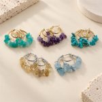 Five colourways of gemstone chip double hoop earrings arranged together on stone