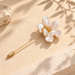 Gold-toned pearl flower stick pin with layered pearl petals and a small beaded center