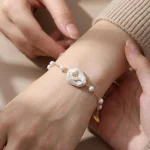 Butterfly baroque pearl station bracelet worn on a wrist