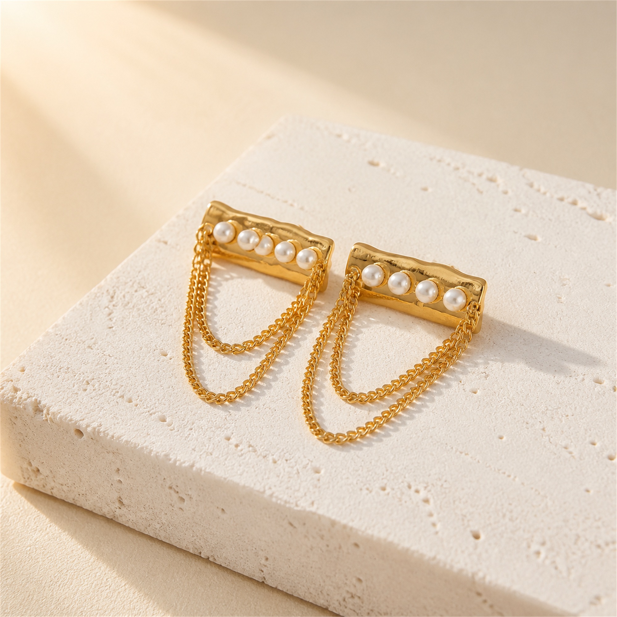 Front view of pearl bar earrings with two chain tassel loops