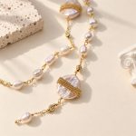 Detail of gold-tone banded baroque pearls and hand-linked freshwater pearls on a long necklace