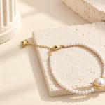 Lobster clasp and extender of a fine freshwater pearl bracelet with a bezel-set centre pearl