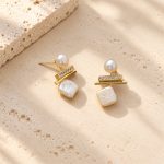 Front view of square pearl drop earrings showing irregular pearl surfaces and slim sparkling bars