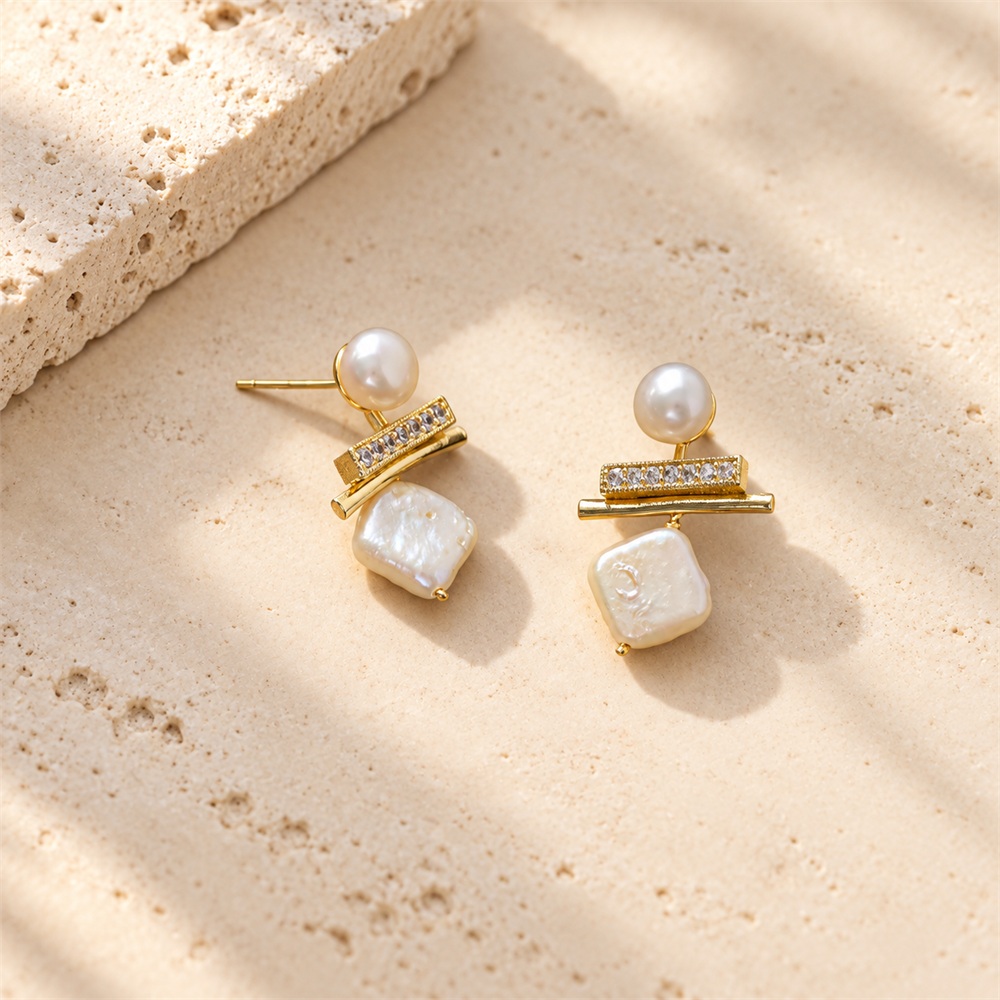 Front view of square pearl drop earrings showing irregular pearl surfaces and slim sparkling bars