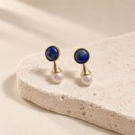 Angled view of lapis lazuli pearl earrings showing gold-toned flared connections