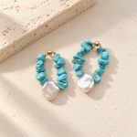 Close front view of turquoise chip and pearl teardrop hoop earrings