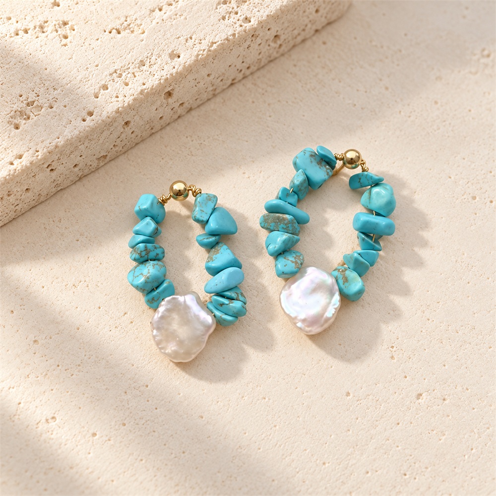 Close front view of turquoise chip and pearl teardrop hoop earrings