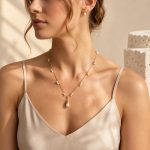 Freshwater pearl fringe Y necklace worn with its pearl pendant at the centre of the neckline