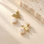 Back view of pearl drop earrings showing stud posts and open-backed bar settings