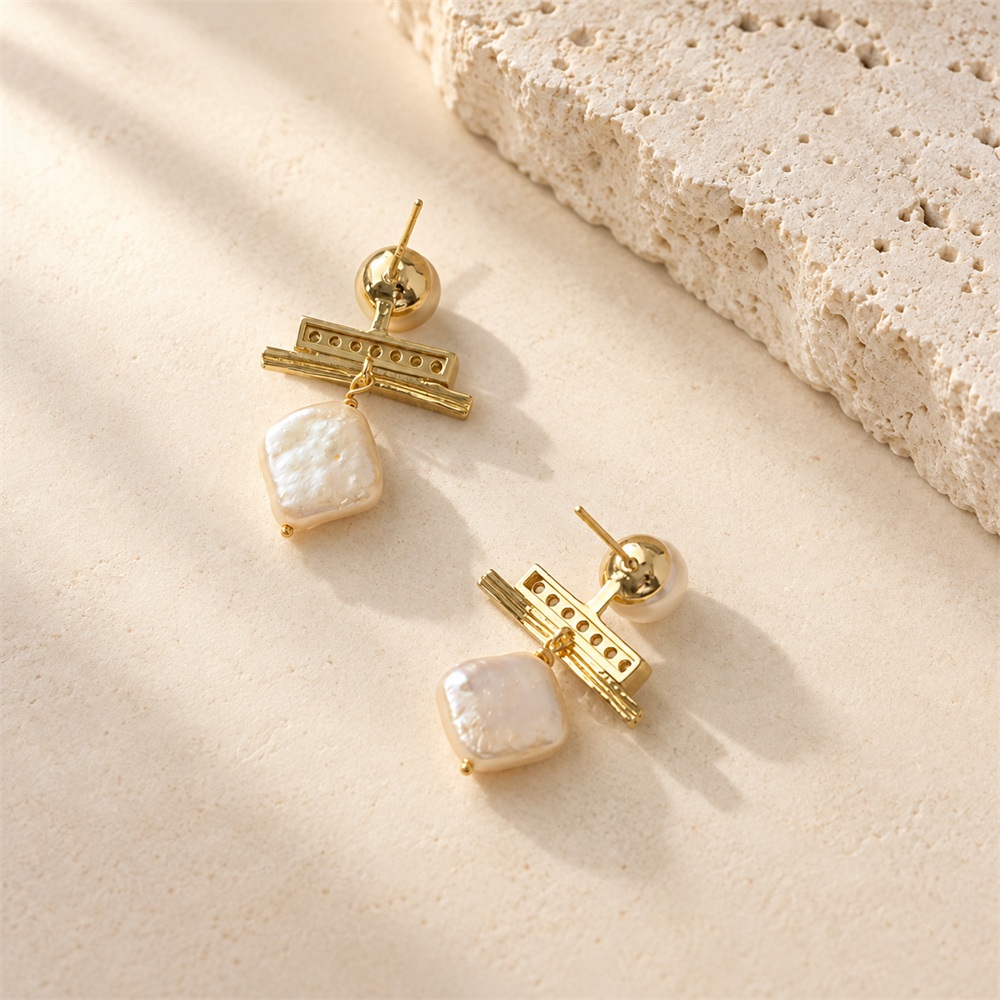 Back view of pearl drop earrings showing stud posts and open-backed bar settings