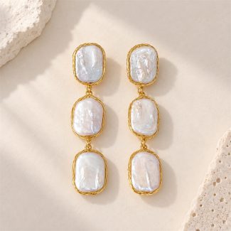Front view of triple-drop earrings with three rectangular baroque pearls in golden wire frames