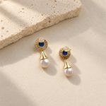 Back of lapis lazuli pearl drop earrings, showing textured settings, posts and clear earring backs