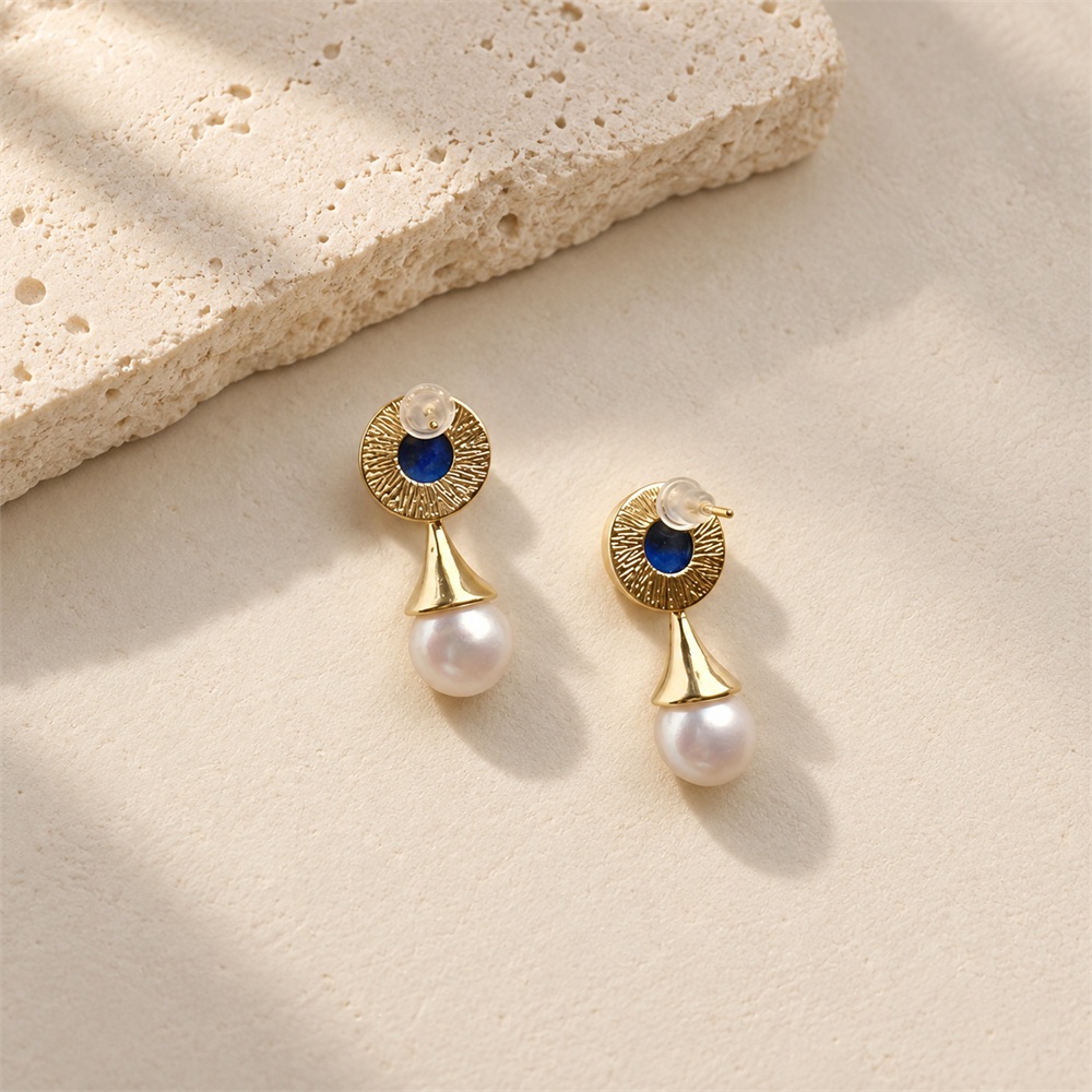 Back of lapis lazuli pearl drop earrings, showing textured settings, posts and clear earring backs
