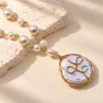 Close view of the wire-wrapped coin pearl pendant and linked pearl necklace