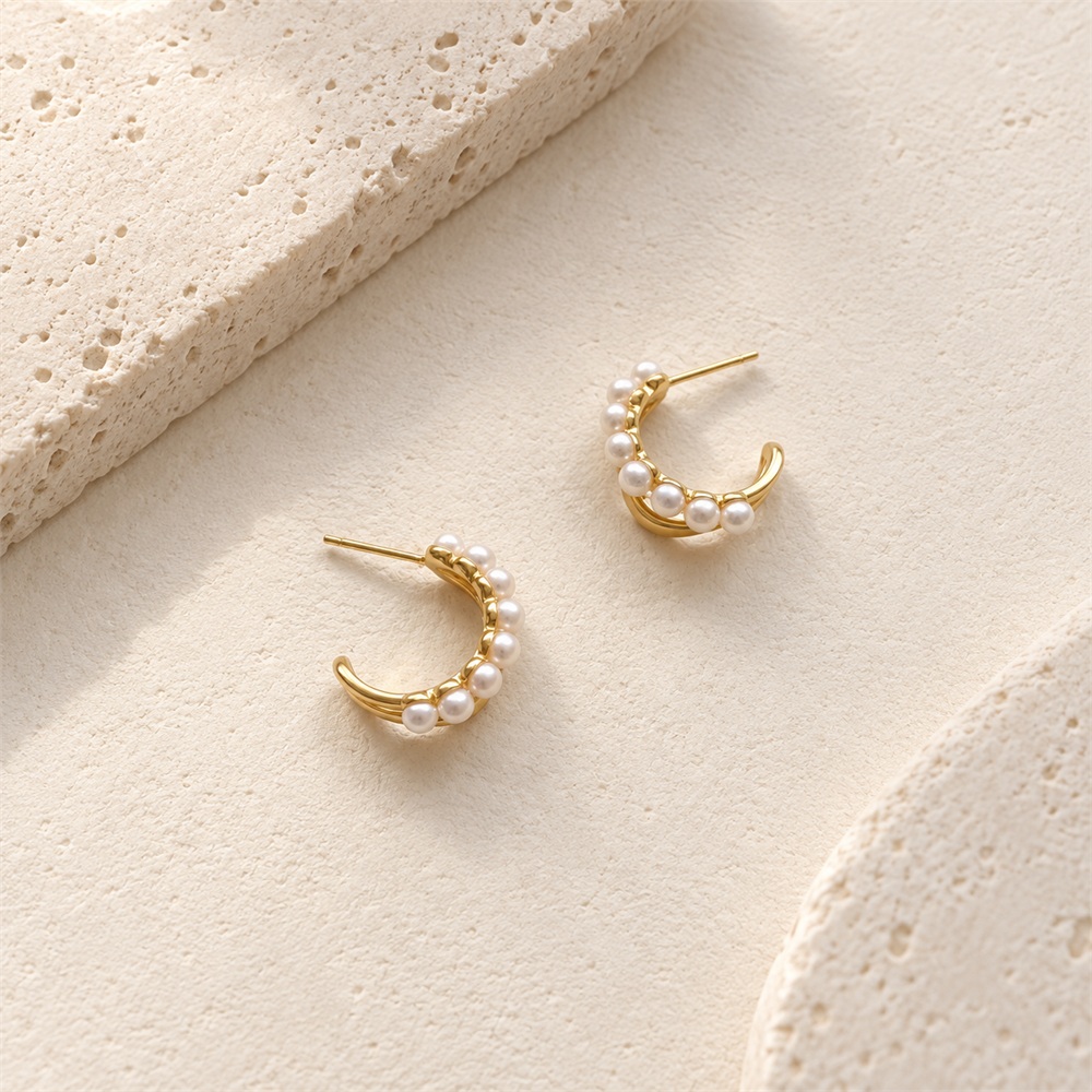 Pair of freshwater pearl crescent stud hoop earrings in a front view
