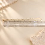 Freshwater pearl fringe necklace laid alongside a ruler