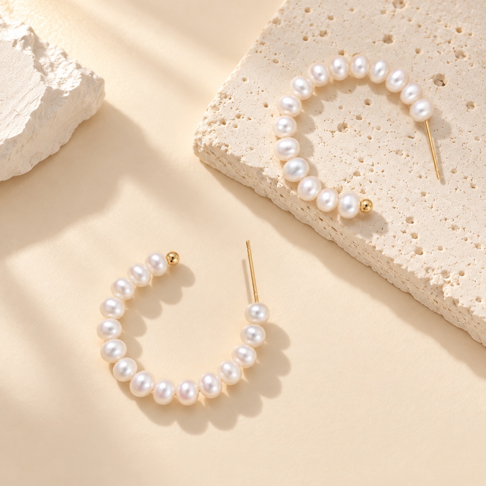 Close-up of freshwater pearl hoops showing open ends, stud posts and rows of small pearls