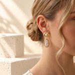 Molten-style baroque pearl dangle earring worn with hair swept up