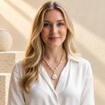 Model wearing a freshwater pearl necklace with a spiral-wrapped coin pearl pendant