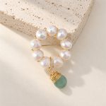 Close view of freshwater pearl wreath pin and green jade drop