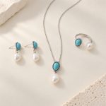 Turquoise and pearl three-piece jewelry set in a silver-tone finish, arranged flat