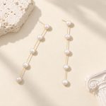 Gold-tone five-pearl linear drop earrings shown flat from the front