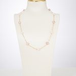 Pink and white freshwater pearl station necklace on a display bust