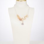 Three-color baroque pearl statement necklace on a white display bust