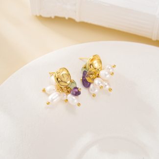 Pearl and multicolour crystal chip cluster earrings laid flat, showing gold-toned studs
