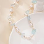 Close-up of raw pale blue aquamarine and baroque pearls in a necklace