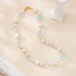 Full aquamarine and baroque pearl necklace laid flat with gold-toned clasp
