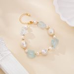 Aquamarine and baroque pearl bracelet laid flat, showing its extension chain