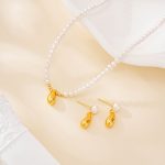Gold-tone teardrop pearl necklace and matching earrings