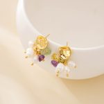 Side view of pearl and multicolour crystal chip stud earrings on a white display