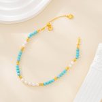 Turquoise bead and freshwater pearl bracelet with gold-tone spacers and extender laid flat