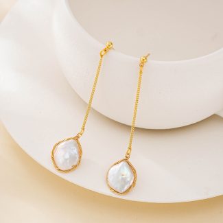 Gold-tone chain drop earrings with wire-framed baroque pearl pendants hanging from stud posts